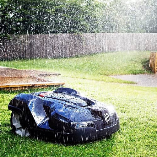 Image of an Automower mowing in the rain