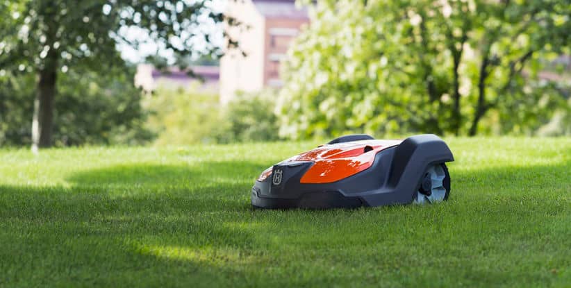 Image of a Husqvarna Automower mowing the lawn.