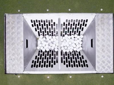 Ball pit where automatic picker drops golf balls to be washed and transported