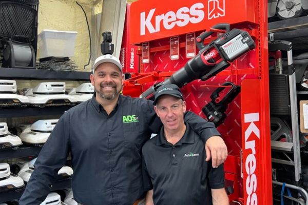 Joe Langton and friend standing in front of a KRESS display