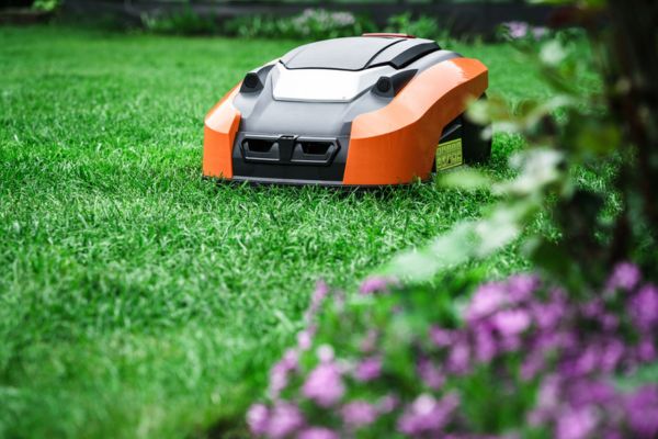 Photo of a robotic lawn mower for landscapers cutting the lawn of a customer
