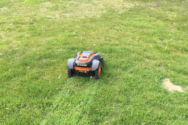 Robotic lawn mower on a nicely cut lawn