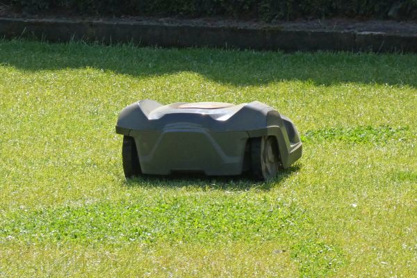 Photo of a robotic mower for business owners automatically cutting the lawn of their property.