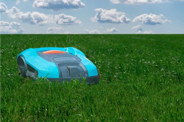 A commercial robotic lawn mower cutting tall grass