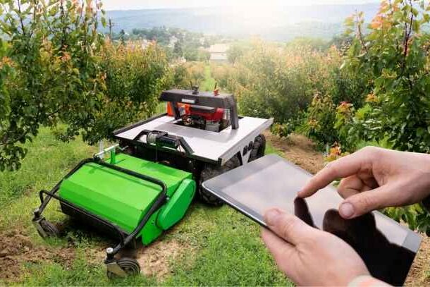 A remote control mower operated on a large agricultural property.