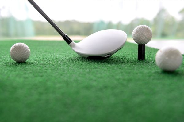 Robot golf ball collector at work on a driving range.