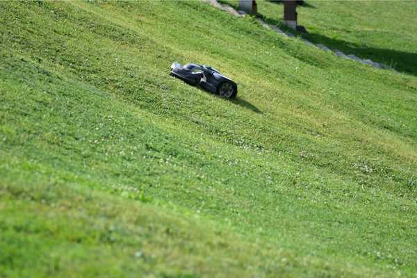 A robotic fairway mower mowing uphill.
